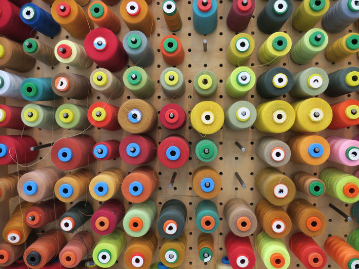 Full frame shot of multi colored thread spools