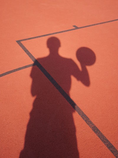 Shadow of player on basket ball court