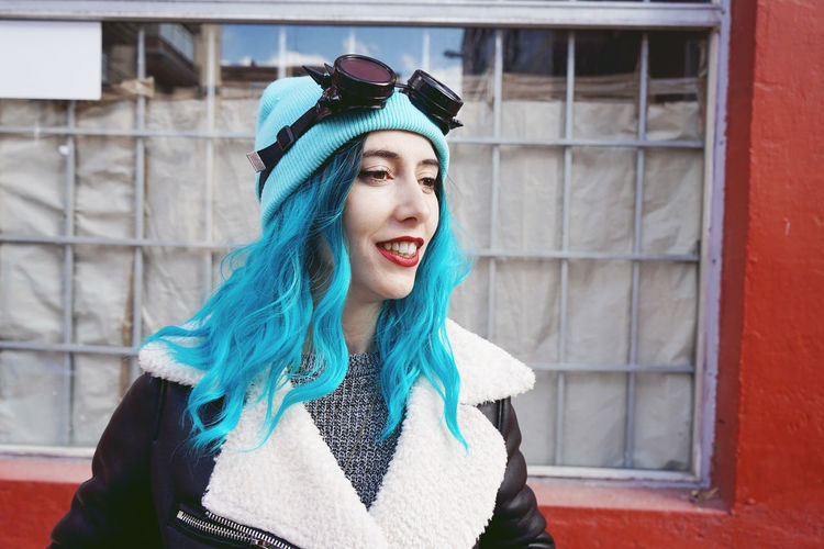 Close-up of fashionable woman with dyed blue hair in city