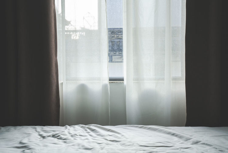 View of curtain by window at bedroom