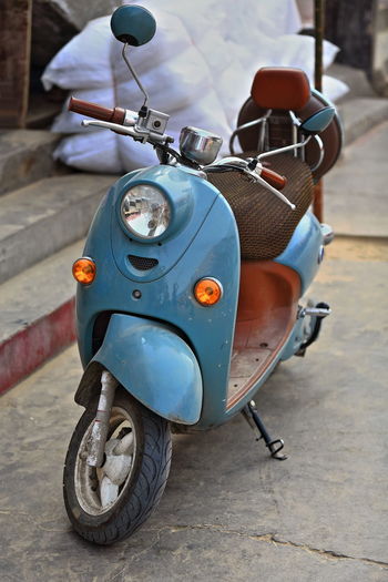 Close-up of motor scooter parked on street