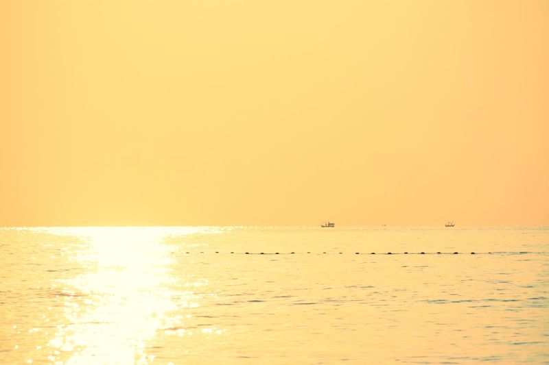 Scenic view of sea against orange sky