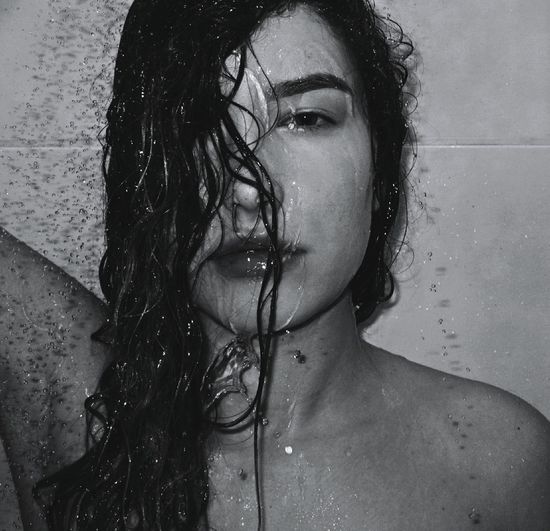 Portrait of young woman in shower