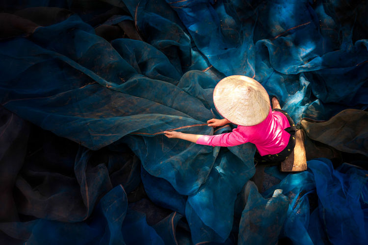 High angle view of woman holding fishing net