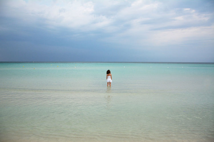 Girl wading in sea