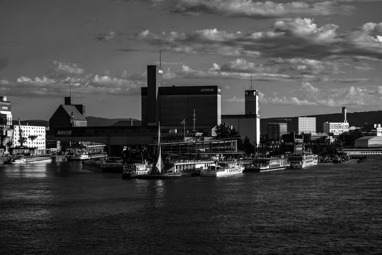Boats in rhine river at weil am rhein against sky