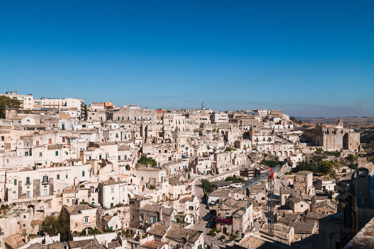 Matera, italy. aerial view of townscape against clear blue sky