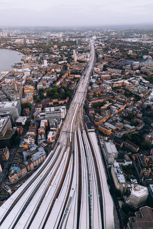 Aerial view of railroad tracks amidst buildings in city