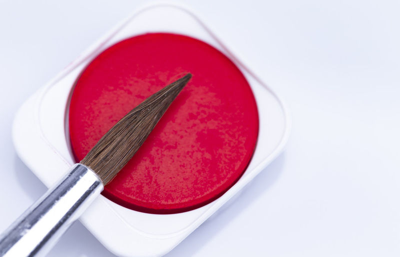 High angle view of red cake on table against white background