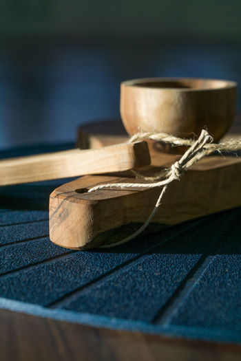 Close-up of wooden bowl and cutting board on table