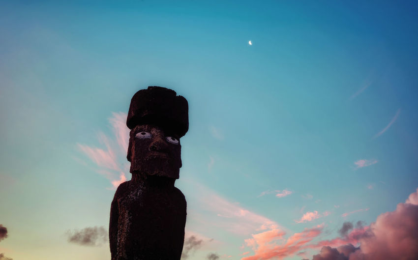 Low angle view of statue against sky at dusk
