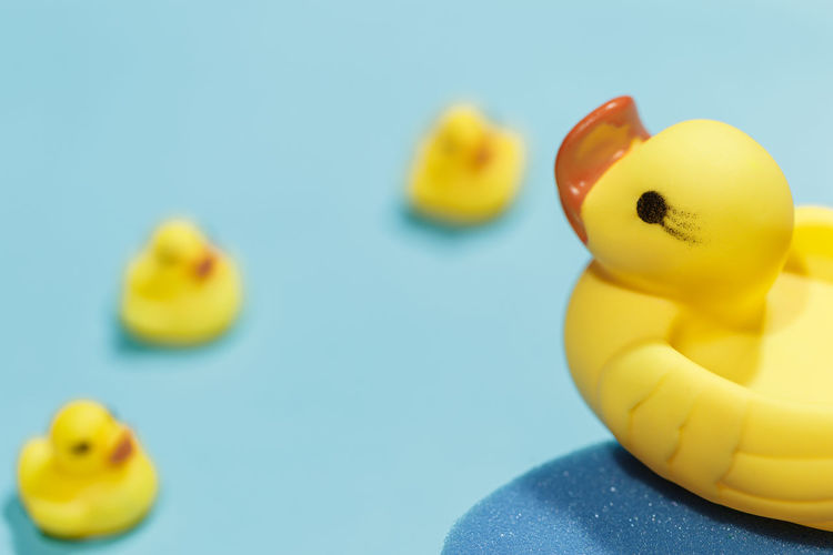Close-up of yellow toy against blue background
