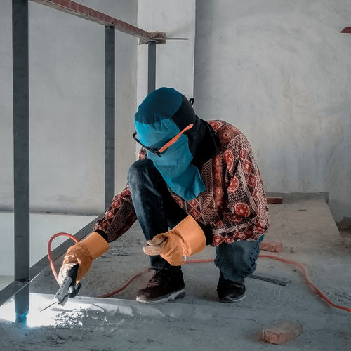 Rear view of man working at construction site