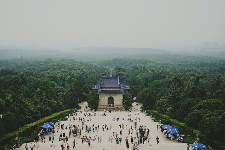 High angle view of crowd visiting sun yat-sen mausoleum surrounded by trees against sky