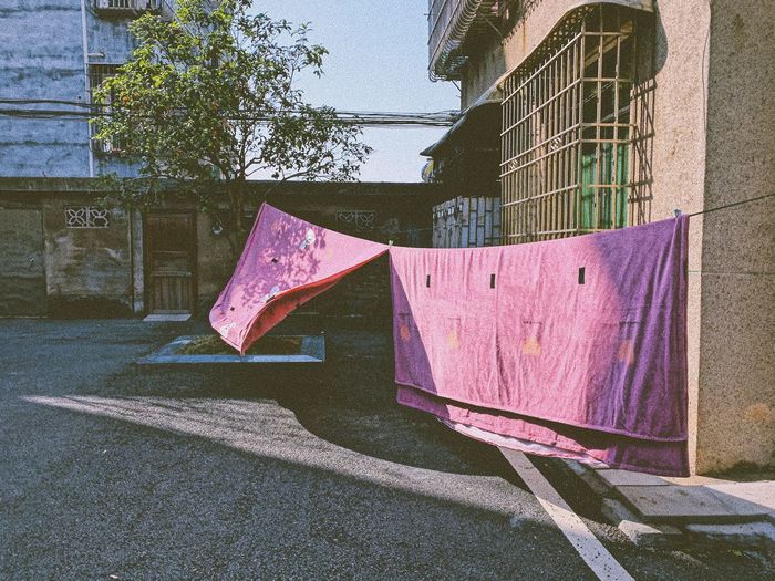 Clothes drying against wall in city