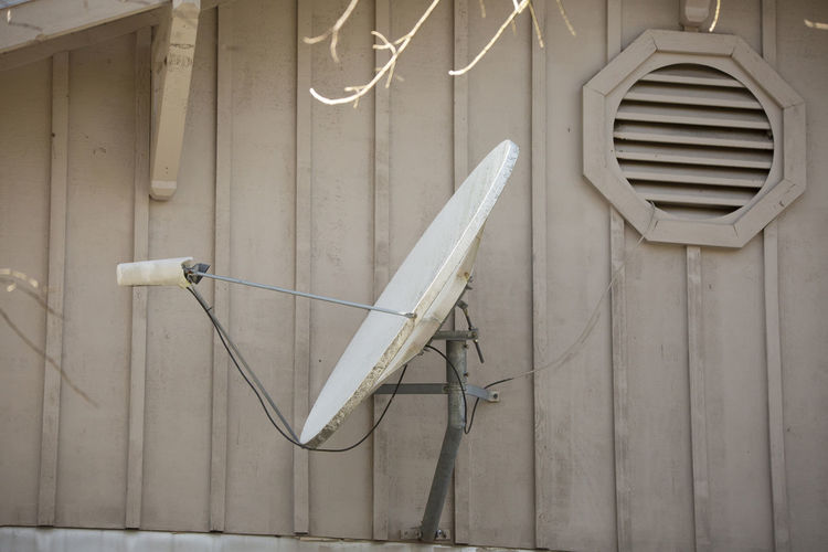 Satellite on an awning of a brown building