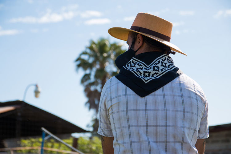 Back portrait of man wearing argentinian traditional clothing