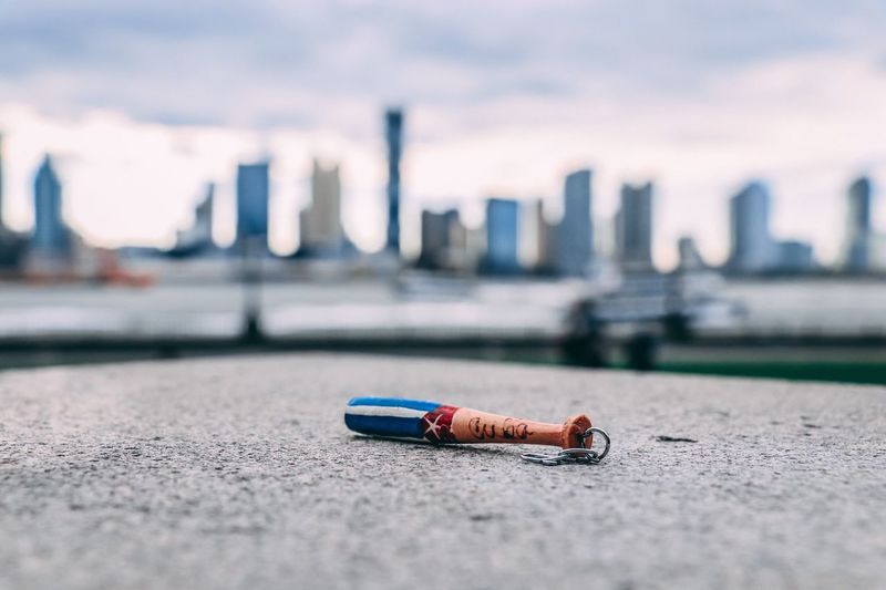 Baseball bat on retaining wall against urban skyline