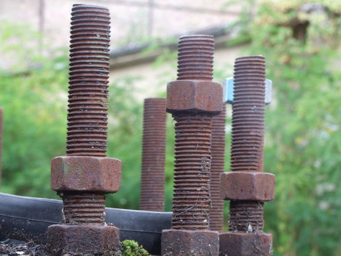 Close-up of abandoned rusty nut bolts