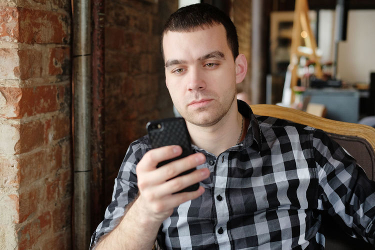 Portrait of young man using mobile phone
