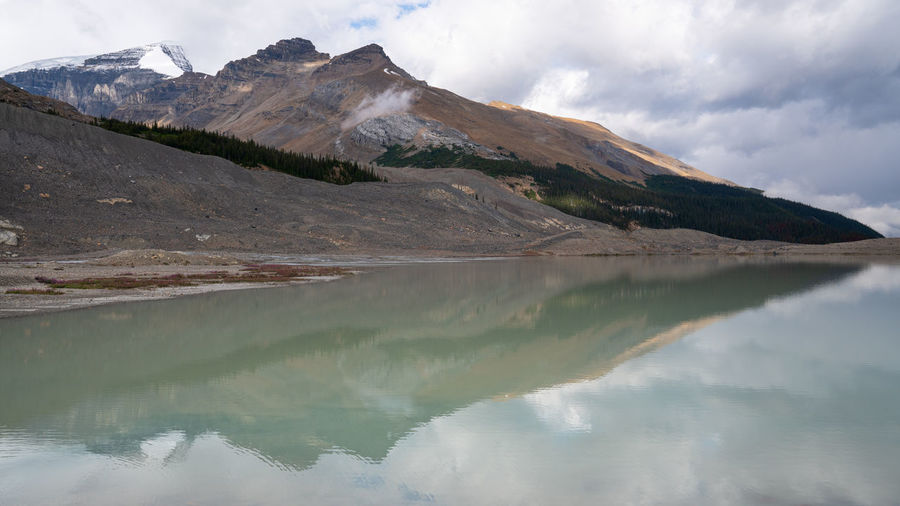 Scenic view of lake and mountains against sky