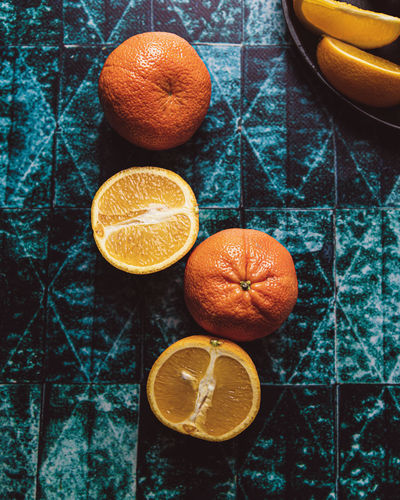 Clementines and oranges in green tiled vinyl backdrop flatlay