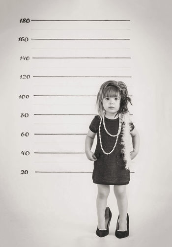 Black and white baby portrait in gangster costume at the police station