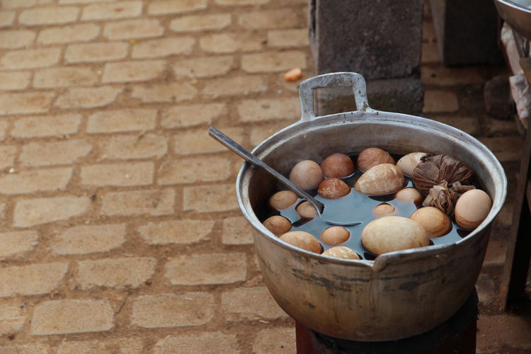 Close-up of boiled eggs in cooking pot for sale on street