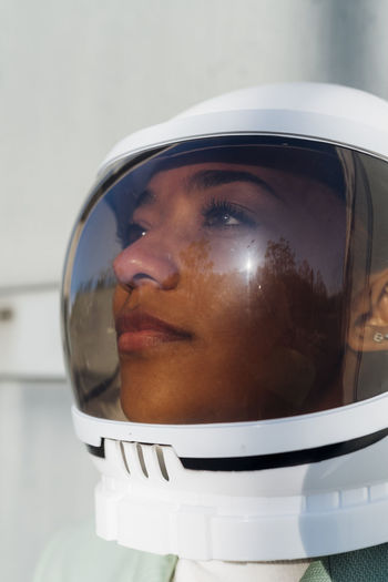 Thoughtful businesswoman with space helmet