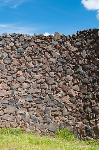 View of rocks on field against sky