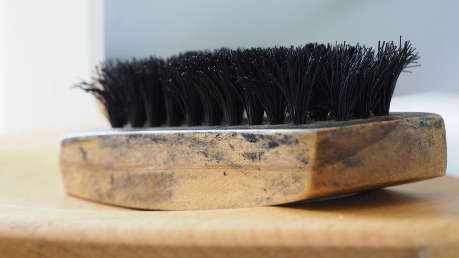Close-up of brush on wooden surface