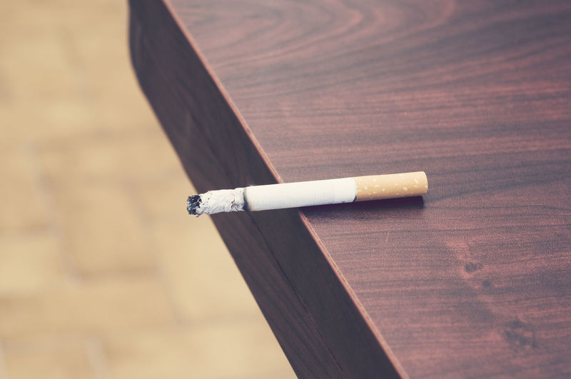 Close-up of cigarette butt on table