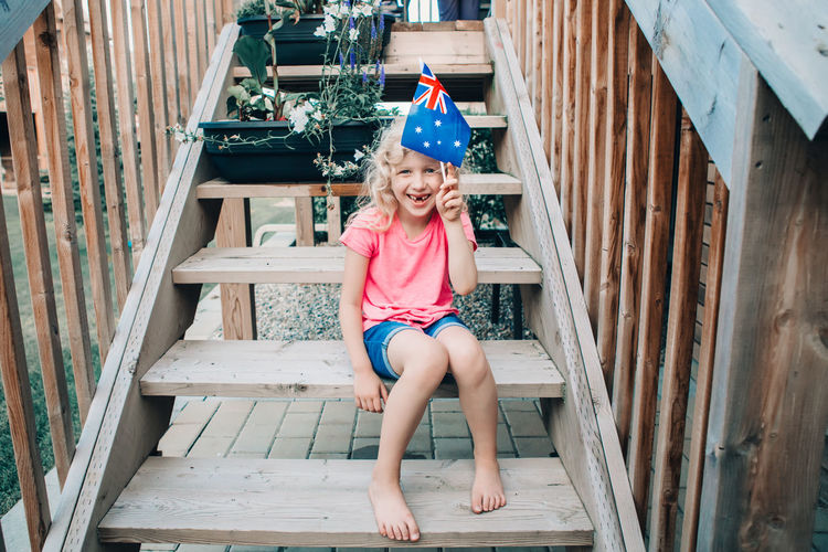 Adorable cute happy caucasian girl holding australian flag. kid celebrating australia day holiday 