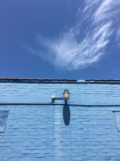 High section of wall against blue sky