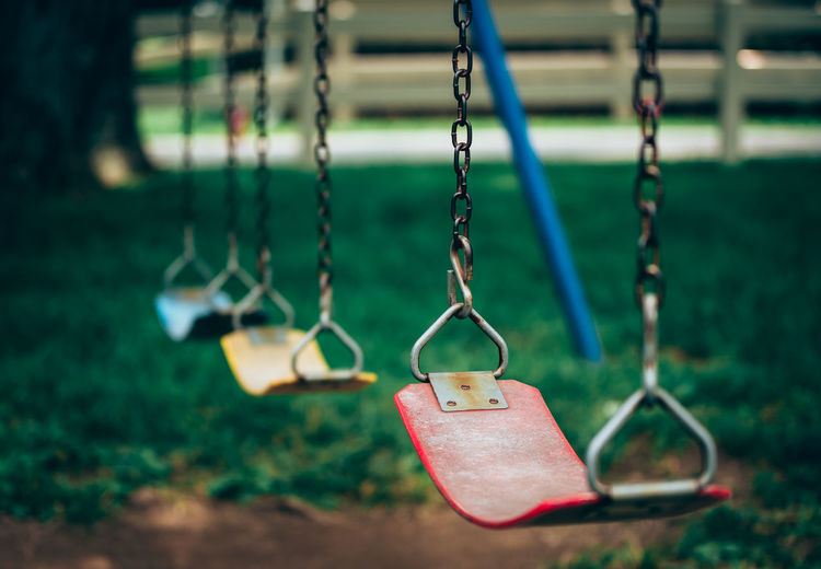 Close-up of swings in playground