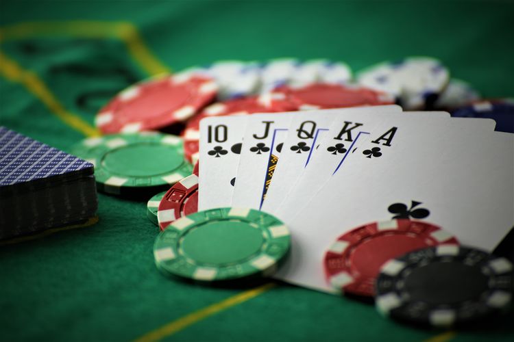 Close-up of playing cards and gambling chips on table