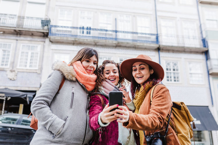 Female tourist using smart phone in city
