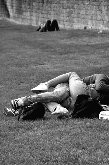 Couple lying on field at park