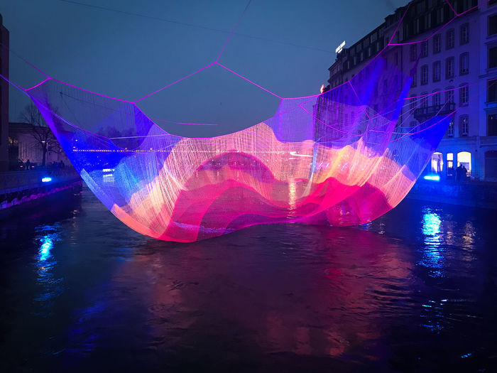 Digital composite image of illuminated swimming pool at night