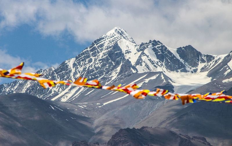 Low angle view of bunting against snowcapped mountains