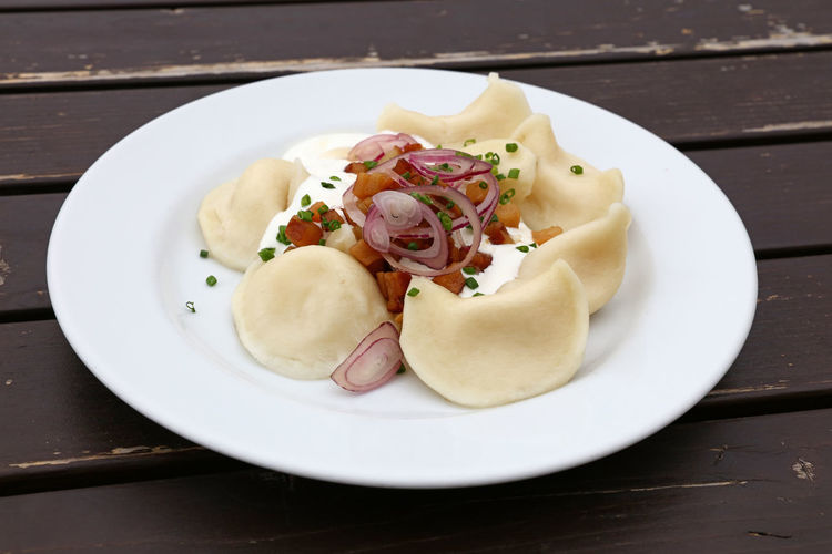 High angle view of pierogi served in plate on table