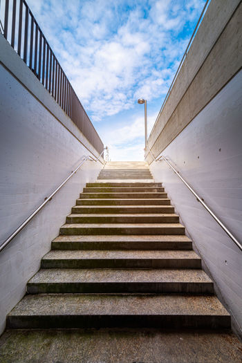 Low angle view of staircase by building against sky