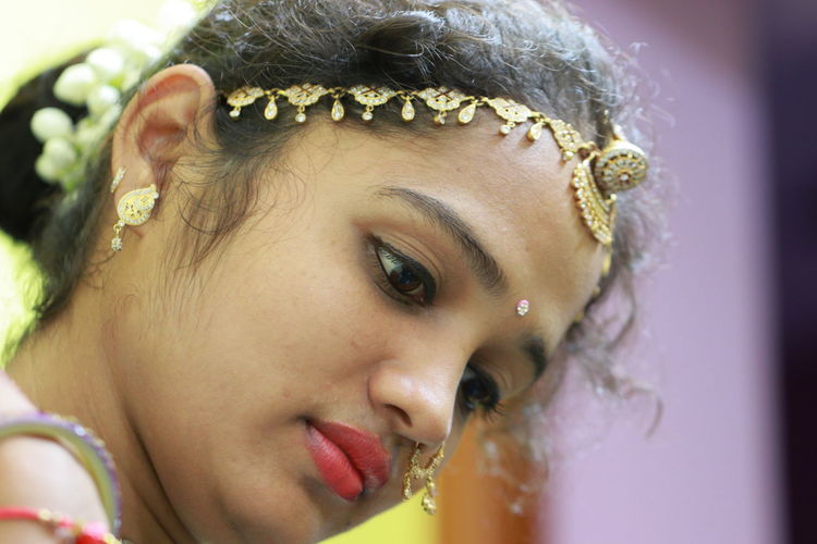 The face of a beautiful north india girl with gold rakhdi/borla is the traditional rajasthani head 