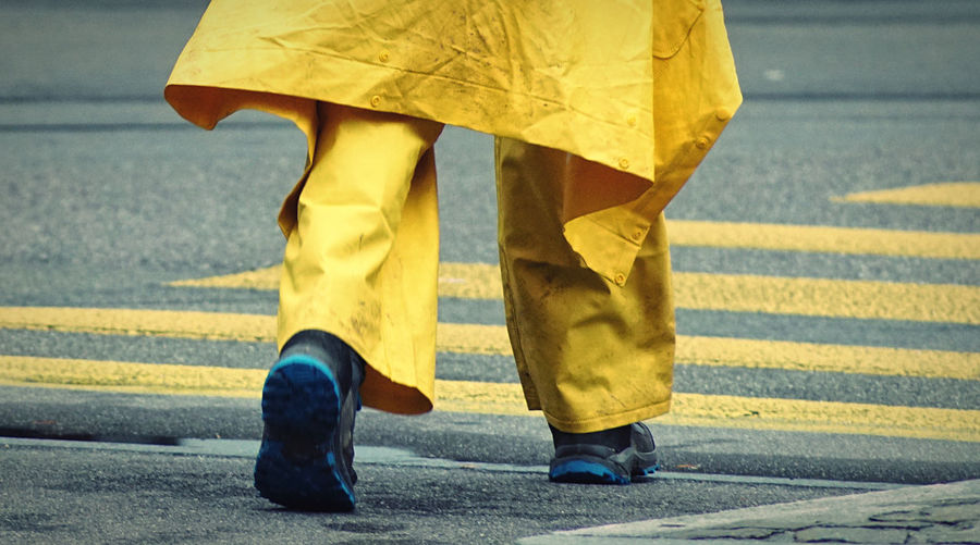 Low section of people walking on road
