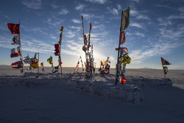 International flags planted on the salt flats of uyuni in bolivia