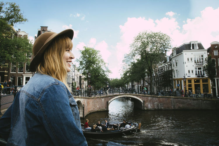 Smiling woman overlooking canal and city