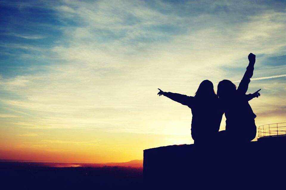 silhouette, sunset, sky, cloud - sky, lifestyles, orange color, cloud, leisure activity, outline, men, beauty in nature, standing, nature, outdoors, scenics, holding, built structure, low angle view