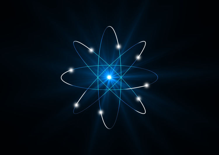 Close-up of abstract atom against black background