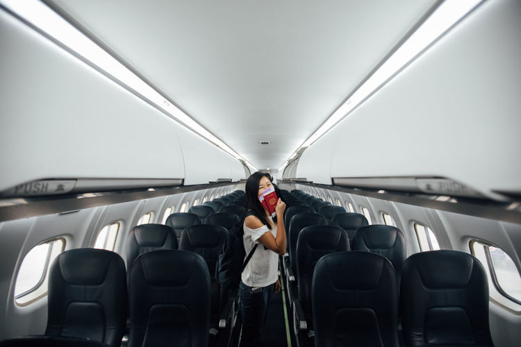 Woman standing in airplane