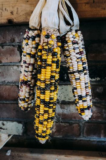 Close-up of corns hanging at market stall
